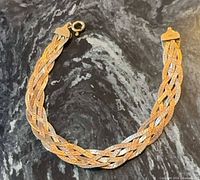 bracelet laid flat showing full braided design and clasp