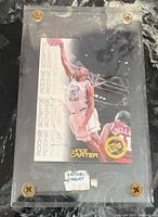 Front view of autographed Vince Carter Rookie Scripts card in acrylic case
