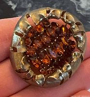 Front view showing full brooch design and stones