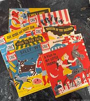Stack of eight CRG children’s record jackets on black surface