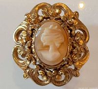 Front view of shell cameo brooch pendant