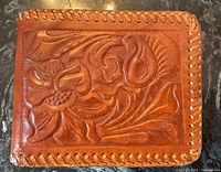 Front exterior showing tooled floral design and laced edge