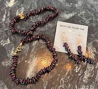 Complete set showing two bracelets and earrings on card