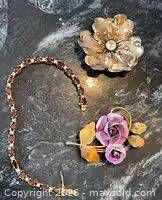 Overall view of bracelet and two brooches
