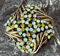 Front view of brooch showing rhinestone colors and metalwork