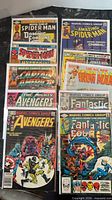 Two vertical stacks of 10 bagged Marvel comics showing titles and cover art