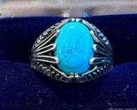Front view of ring showing turquoise cabochon and claw design