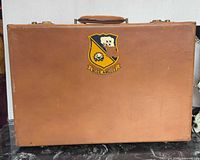 Front of brown briefcase with Blue Angels decal