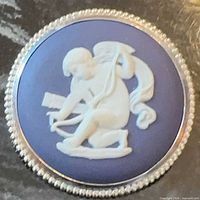 Front view showing blue jasperware cameo with white cherub relief and beaded silver border