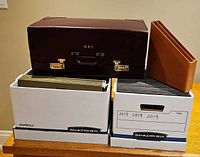 Overall lot: two Bankers Boxes, burgundy leather attache, brown magazine holder