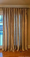 Full view of curtain panel hanging on rod showing length and pattern