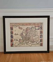 Full view framed map on floor against wall