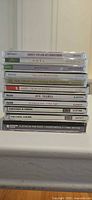 Stack of 11 Christmas choral and classical music CDs showing spine titles and labels