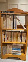 Full view of three-shelf bookcase holding all paperbacks