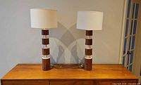 pair of lamps on wooden surface showing full form
