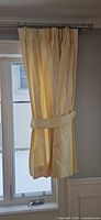 Curtain panel hung on rod with tieback
