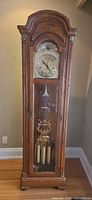 Full frontal view of Salem grandfather clock showing cabinet, dial, pendulum and weights