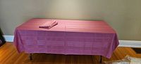 Full view of one tablecloth draped over table showing size and color