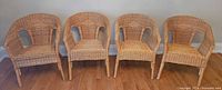Front view of all four matching wicker rattan armchairs