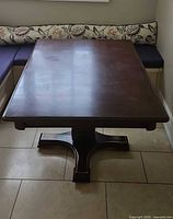 Full view of square pedestal dining table in dining nook