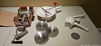 Overall lot showing grinder parts, food mill, ricer and discs