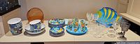 Full lot on counter: plates, bowls, tumblers, goblets, tray, amber bowls