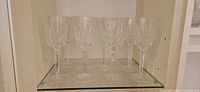 Six of the crystal goblets displayed on glass shelf