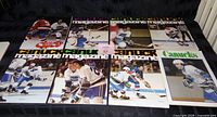 Eight Vancouver Canucks game program magazines laid out showing front covers