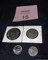 All four coins with two in cardboard flips