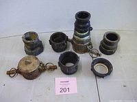 All seven hose fittings laid out on surface