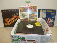 Box of records with visible album jackets