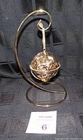Ornament hanging on gold-tone stand