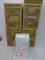 Four boxed Lightolier fixtures, one unboxed