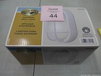 Sealed retail box showing Hampton Bay branding and fixture image