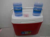 Front view of red Igloo Laguna 28 cooler with two ICEpak packs on lid
