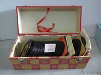 Open record case showing stack of 45 RPM singles