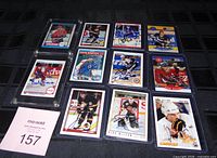 Grid view of all 11 signed hockey cards in sleeves and holders