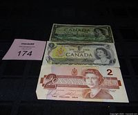 Fronts of the three banknotes showing denominations and portrait details