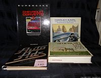 Group shot of all four automotive books upright and stacked