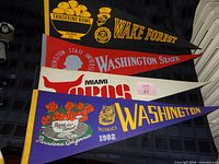 Stack showing Tangerine Bowl, Wake Forest, Washington State, Miami Toros, Rose Bowl, Washington Huskies 1982 pennants
