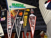 Top view showing Seattle Sounders, Vancouver, 1994 Grey Cup Champions, Missouri and 2011 Grey Cup Vancouver pennants
