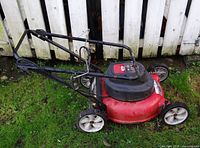 Side view of full MTD electric mower showing deck, handle, wheels
