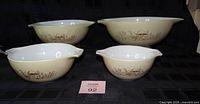 All four nested Pyrex Forest Fancies bowls