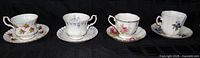 Front view of four cup and saucer sets