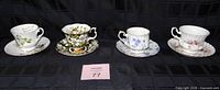 All four cup and saucer sets side by side