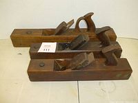 Three wooden planes side view with label 111