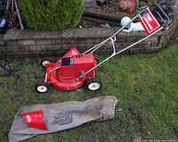 Full mower with bag and discharge chute on grass
