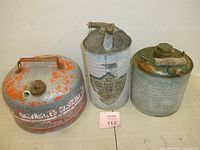 Three galvanized gas and oil cans front view