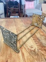 Book holder fully extended on table showing both end panels and rods