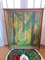 Full view of framed oil painting showing forest scene